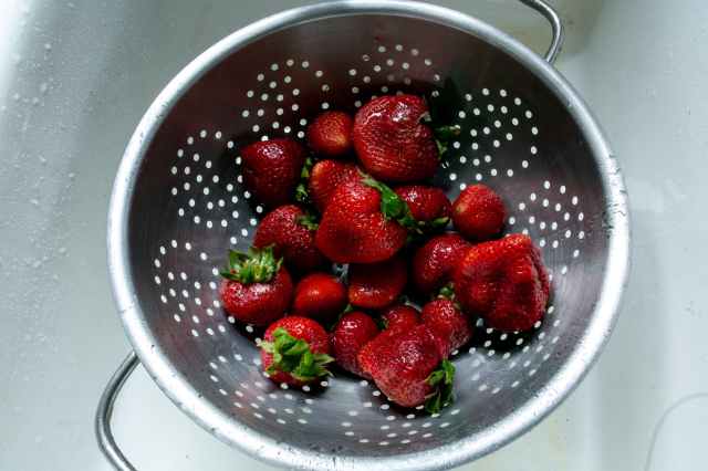 high angle photo of strawberries in strainer